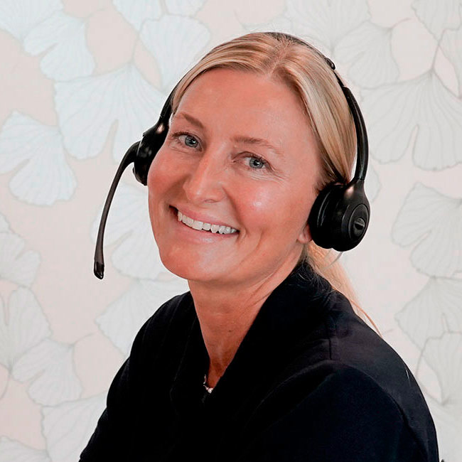 Sygeplejerske sidder med headset på - klar til at modtage opkald.